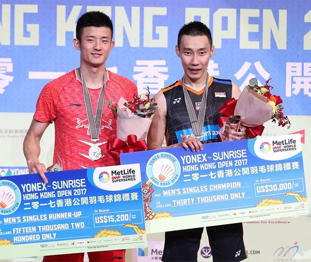 Lee Chong Wei (R) poses with Chen Long on the podium.